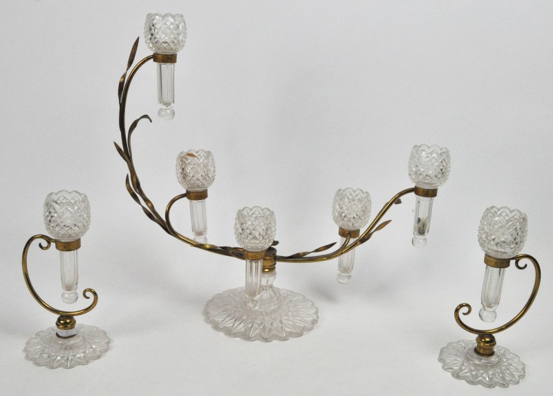 Tafelgarnituur van geslepen kristal met twee enkele en een vijfvoudige vaas in verguld koperen houder in de vorm van halmen.