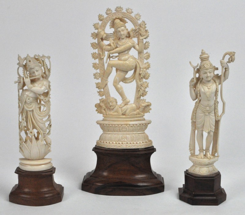 Drie hindoeïstische beeldjes van gebeeldhouwd ivoor. Het grootste (H. 25 cm) stelt Nataraja, de dansende Sjiva voor. Daarnaast een fluitspelende Krisjna en een andere. Indisch werk, eerste helft XXste eeuw. Op houten sokkeltjes.