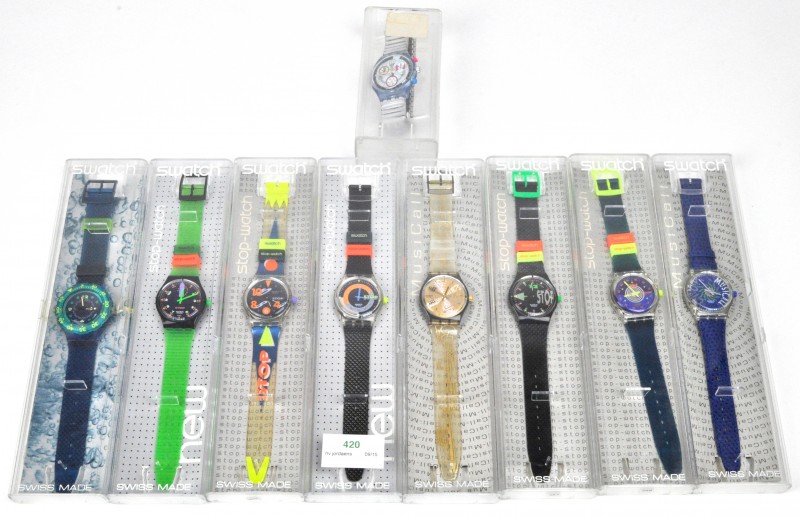 Negen verschillende kleurrijke horloges in originele doosjes.