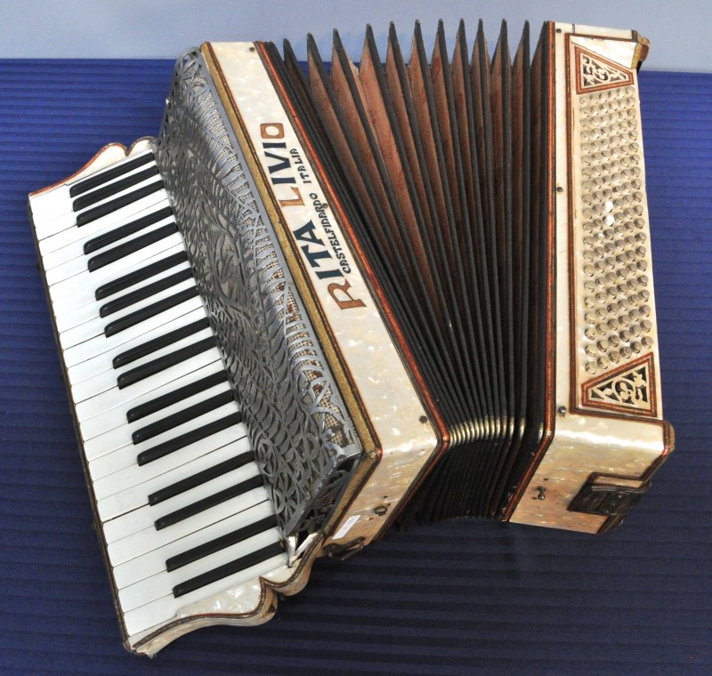 Een oude accordeon, afgewerkt met paarlemoer en inlegwerk. Kleine slijtage en manco’s.