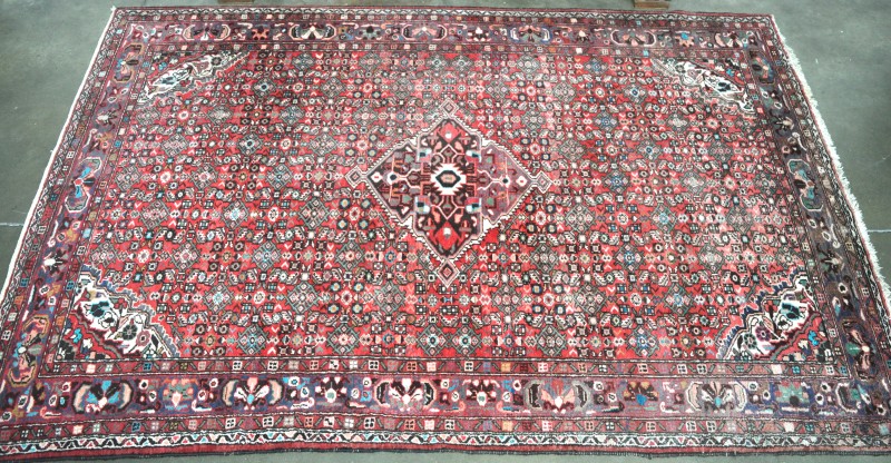 Een Perzisch wollen tapijt. Handgeknoopt.