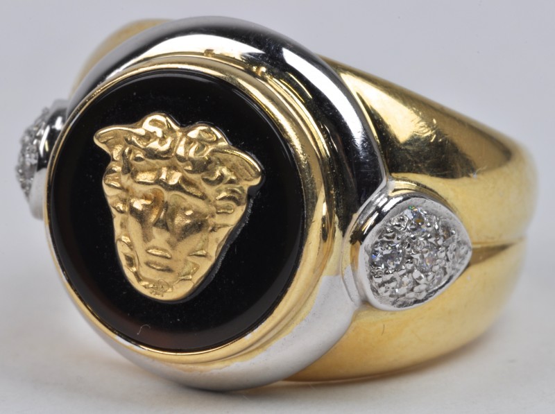 Een 18 karaats wit en geel gouden ring met Medusa afbeelding en fantasiestenen.