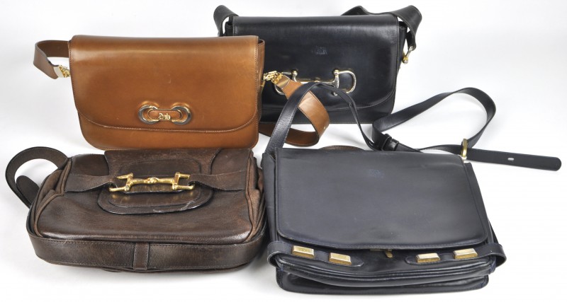 Vier diverse handtassen in leder, waarvan drie van het merk Céline en één van Delvaux. Enige slijtage.