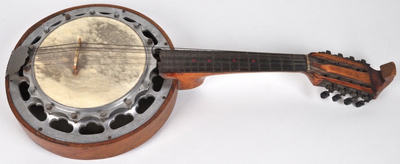 Een banjo met gefineerde kast, achteraan versierd met een ingelegde banjospelende clown.