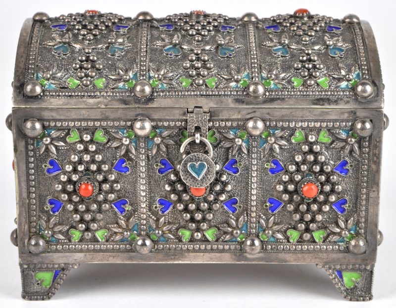 Een zilveren doosje met gegalbeerd deksel, versierd met geëmailleerde details en afgewerkt met bloedkoraal. +/- 690 g Bruto.