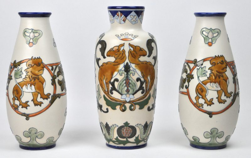 Een driedelig kaststel, bestaande uit drie vazen, versierd met een meerkleurig geglazuurd decor. Begin XXe eeuw.