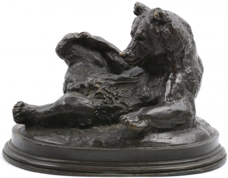 Een liggende beer van donkergepatineerd brons.