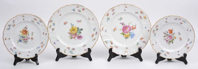 Een lot van twee grote en twee kleine porseleinen borden met een decor van bloemen en vlinders, waarbij de Kleine met een merk van Meissen.