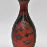 Een vaas met lange, uitwaaierende hals van rood en zwart porselein met een vogeldecor. Japan, XIXe eeuw.