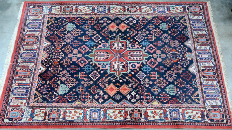 Een handgeknoopt Perzisch tapijt van wol.