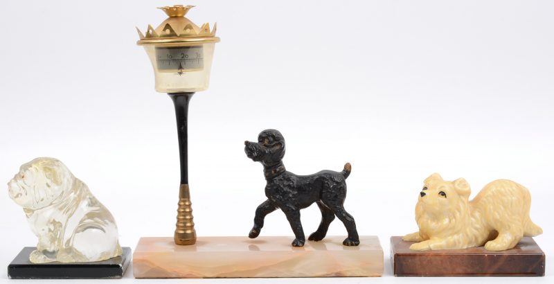 Een lot van twee presse-papiers met een hondje van kunststof en een thermometer in de vorm van een bronzen hondje bij een lantaarnpaal op onyxen voetstuk