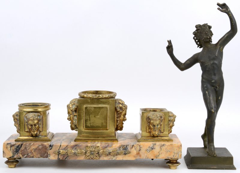 Een inktstel van verguld brons en marmer, waarbij de inktpotten versierd let Bacchushoofden. Manco’s. We voegen er een zamakken beeltenis van Bacchus aan toe.