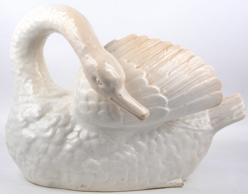 Een jardiniere van mnochroom wit aardewerk in de vorm van een zwaan.