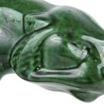 Een art deco tijger van groengeglazuurd aardewerk.