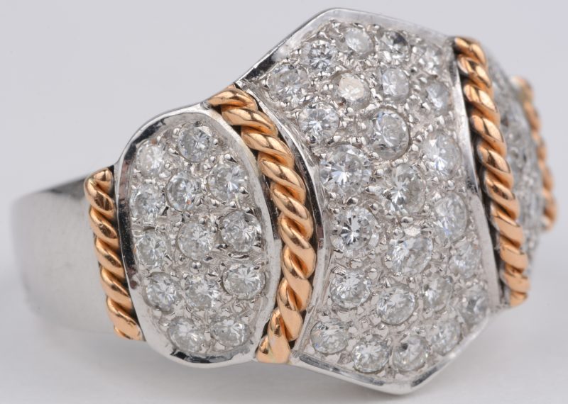 Een 18 karaats wit en geel gouden ring bezet met diamanten met een gezamenlijk gewicht van ± 1,50 ct.