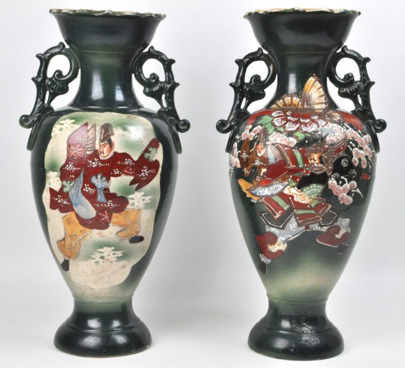 Een paar vazen van meerkleurig Satsuma-aardewerk met een decor van personages in cartouches op groene fond.