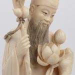 Een beeld van een Chinese wijze met een staf en een bloementuil. Chinees werk, begin XXste eeuw. Op en houten sokkeltje