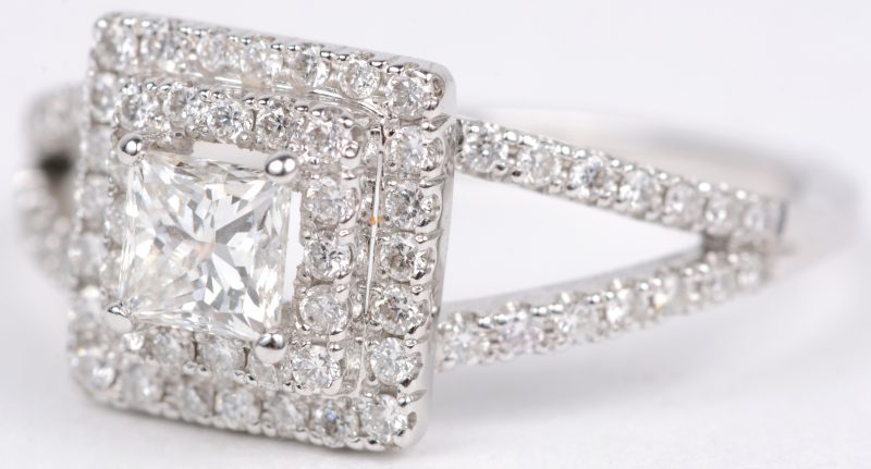 Een 18 karaats wit gouden ring bezet met briljanten met een gezamenlijk gewicht van ± 0,60 ct. en een centrale diamant in markies geslepen van ± 0,50 ct.