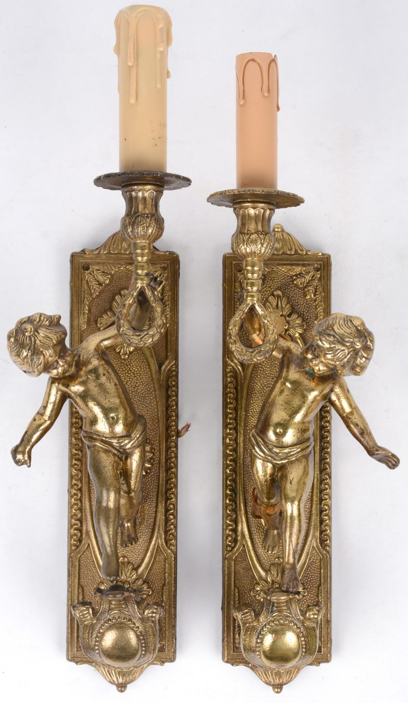 Een paar appliques van verguld brons met elks één lichtpunt, gedragen door een putto.