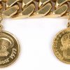 Een 18 karaats geel gouden schakelarmband met vier verschillende munten. Herdenking Rubensjaar 1977. 20 frank Leopold I 1865. Jozef I van Oostenrijk 1915.