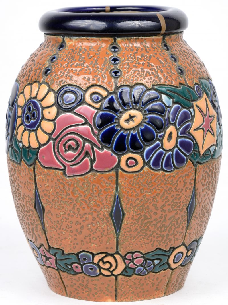Een vaas van meerkleurig aardewerk met een bloemendecor in reliëf. Onderaan gemerkt.
