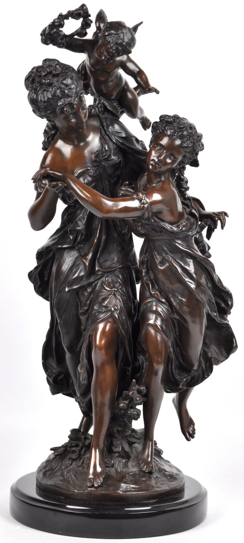 “Twee nimfen en een engeltje”. Een groep van bruingepatineerd brons op een voetstuk van arduin. Naar een werk van Math. Moreau.