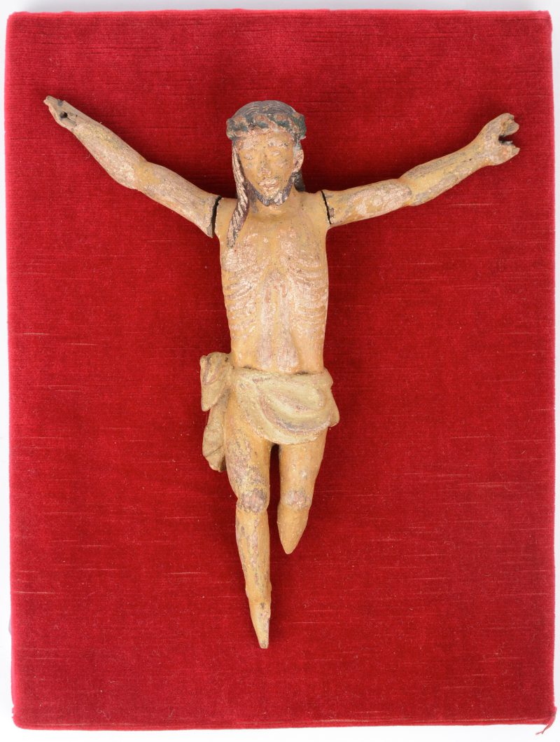 Een antiek Christusbeeld van gepolychromeerd hout. Beschadiging.