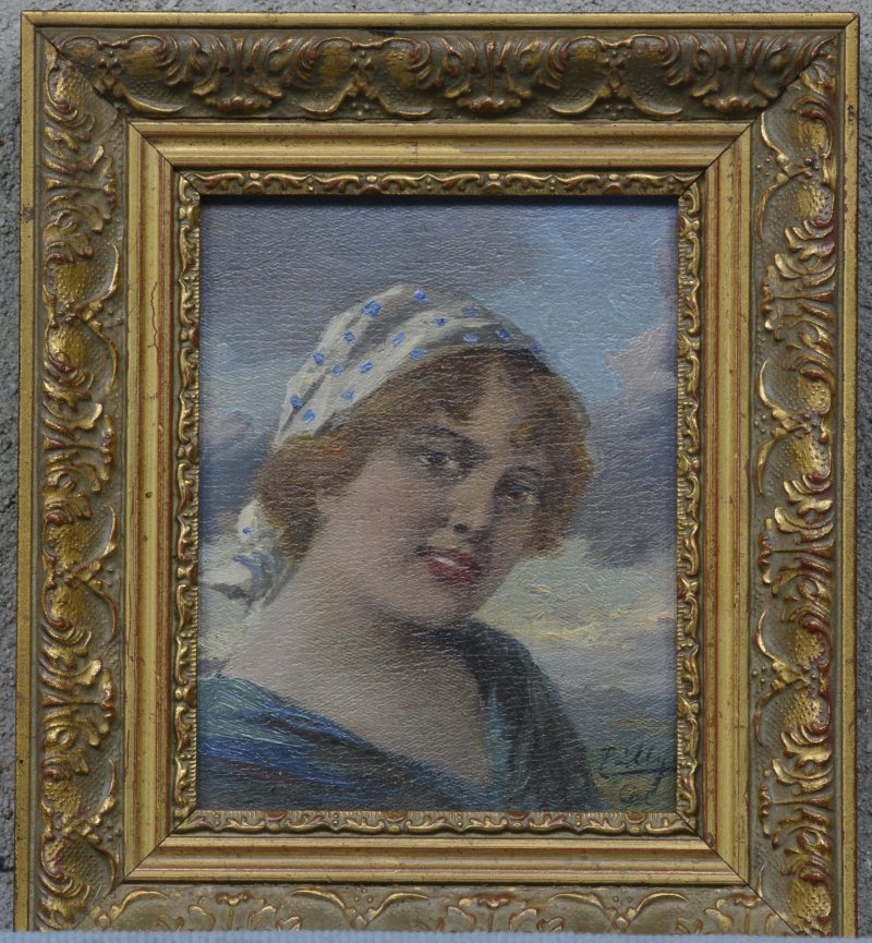 Een portret van een jonge vrouw van rond 1900 .  Olieverf op paneel. Gesigneerd.