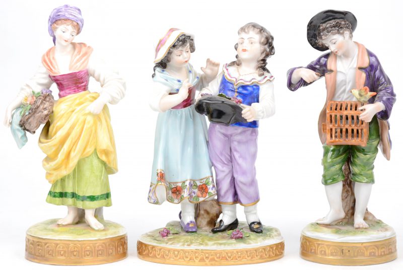 “Koppel” & “Meisjes met hoed”. Drie beeldjes van meerkleurig Duits porselein. Gemerkt.