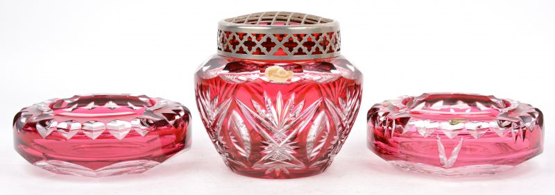 Een lot bestaande uit twee asbakken en een pique-fleur van rood geslepen kristal.