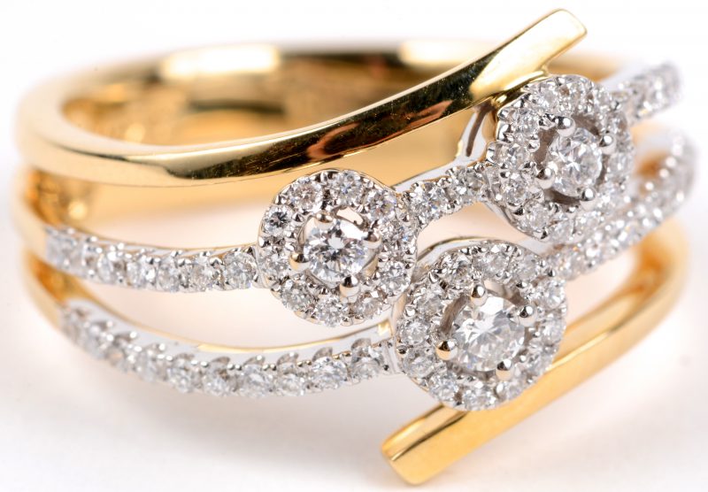 Een 18 karaats wit en geel gouden ring bezet met diamanten met een gezamenlijk gewicht van ± 0,51 ct.
