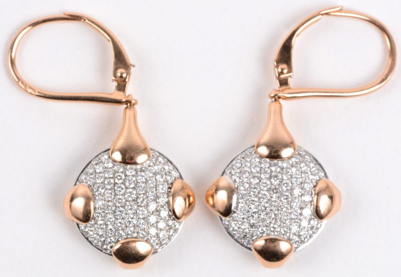 Een paar 18 karaats roze gouden oorbellen bezet met diamanten met een gezamenlijk gewicht van ± 1,32 ct.