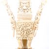 Een Chinese wierookbrander van rijkelijk gesculpteerd ivoor. Op houten sokkel. Gesigneerd.