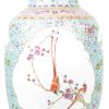 Een vaas van Chinees porselein met een famille-rozedecor van vogels op bloeiende takken in cartouches op een achtergrond van bloemen op lichtblauwe fond. Onderaan gemerkt.