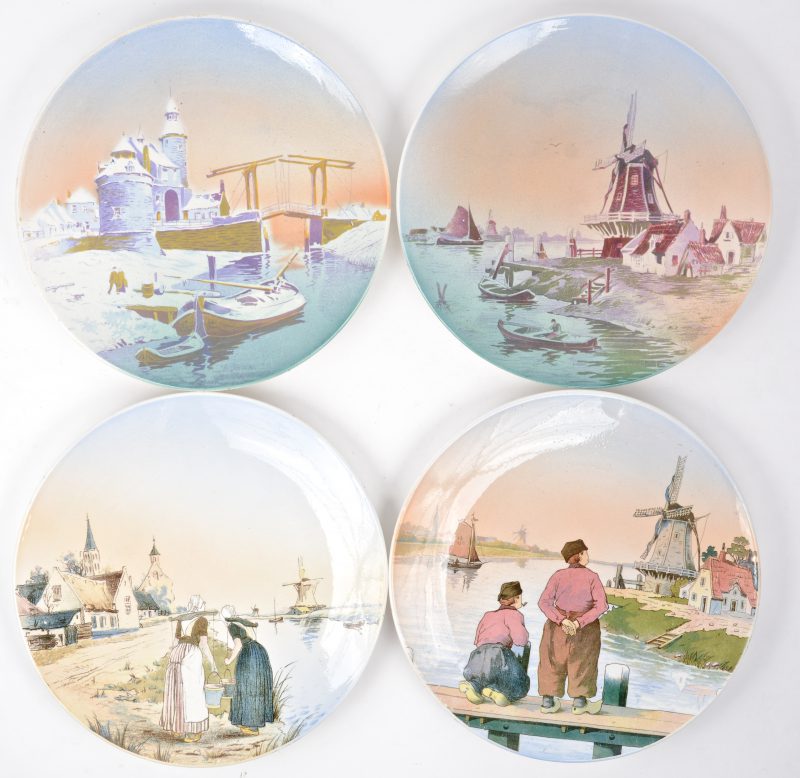 Vier aardewerken borden met meerkleurige Hollandse scènes in het decor. Onderaan gemerkt.