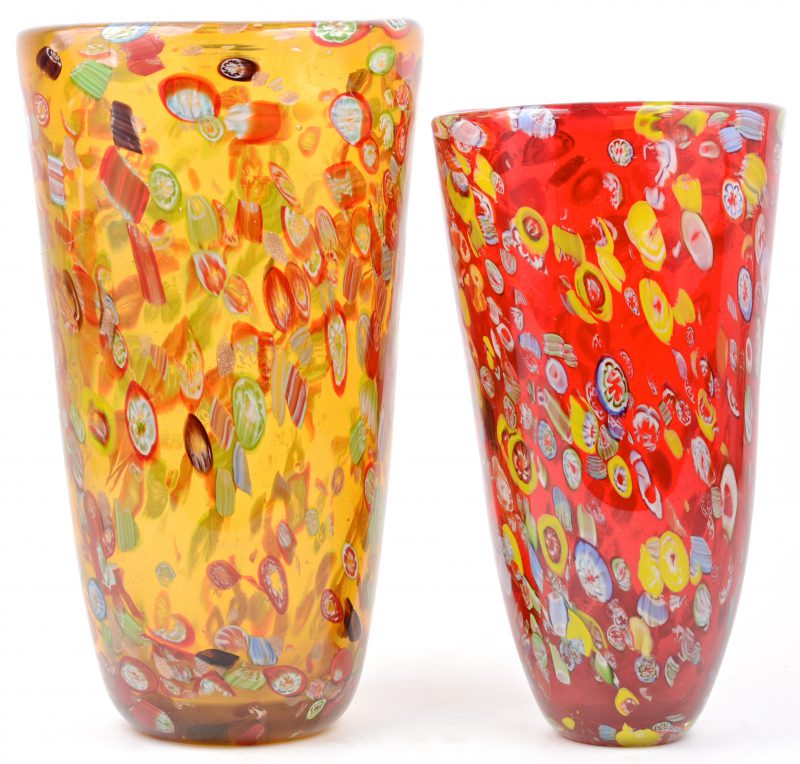 Een paar Murano-vazen. Een van rood glas in de massa en één met oranjegeel glas in de massa. Beiden met mille fleur decoratie.