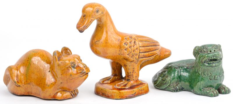 Een zwaan, een tempelleeuw en een kat van geglazuurd Chinees aardewerk.