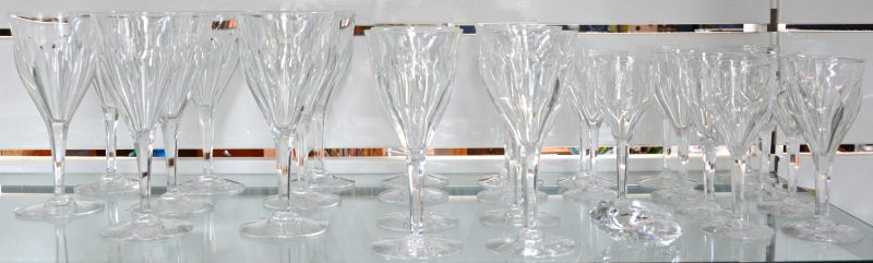 Een gedeeltelijk glasservies van geslepen kleurloos kristal, bestaande uit 8 rodewijnglazen, 8 wittewijnglazen en 11 borrelglaasjes. Vermoedelijk Val St. Lambert. Enkele randschilfers. Bijgevoegd een gestileerde kristallen kikker van Val St. Lambert.