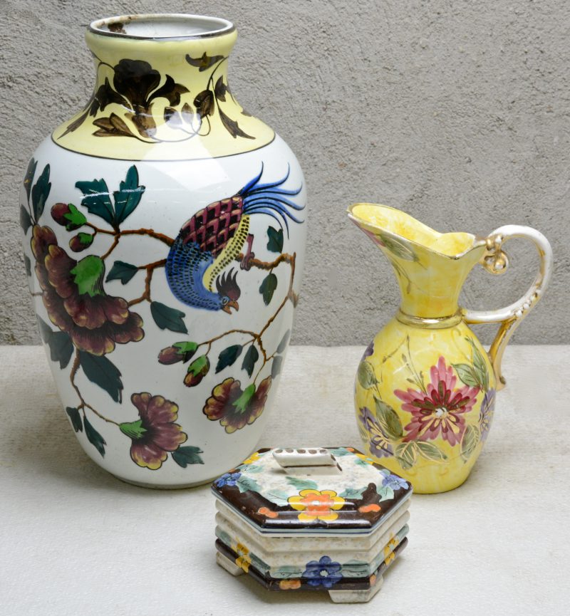 Een grote vaas, een schenkkan en een dekseldoosje van meerkleurig glanzend aardewerk. Onderaan gemerkt.