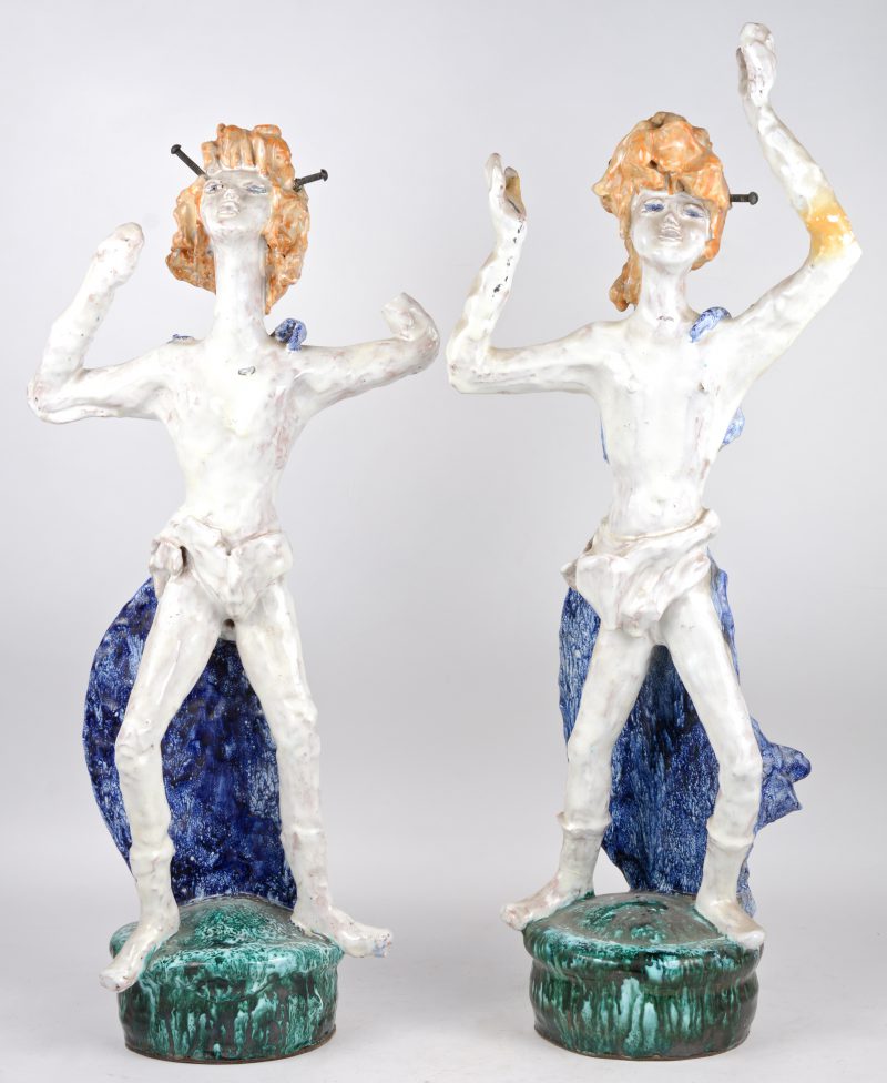 Een paar dansende figuren van meerkleurig geglazuurd terracotta. Eén hand manco.