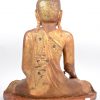 Een antieke zittende Boeddha van goudgepatineerd hout.