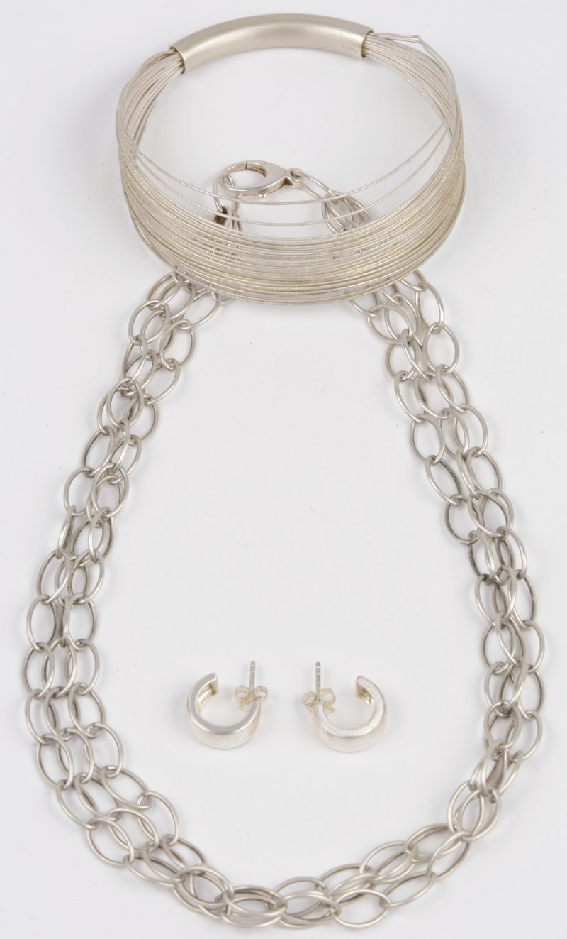 Een schakelketting, een armband en een paar oorbellen van zilver. 925 ‰