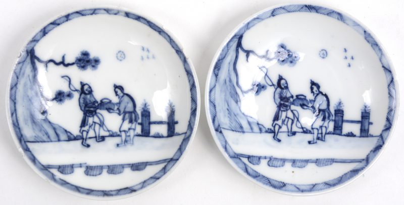 Twee kleine porseleinen bordjes met een blauw op wit Chinees decor. Onderaan gemerkt. XIxe eeuw. Lichte randschade.