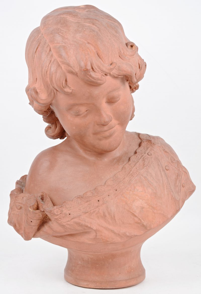 Een buste van een jong meisje van terracotta. Gesigneerd en gedateerd 1884.