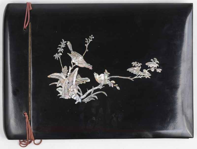 Een Chinees foto-album met zwartgelakte houten kaft, versierd met een parelmoeren decor.