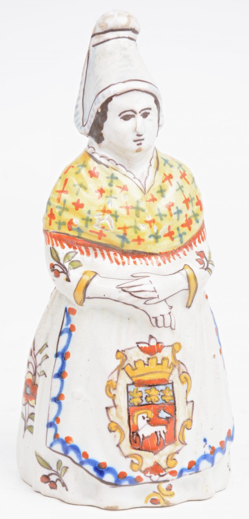 Een bel van meerkleurig aardewerk van Rouen in de vorm van een vrouw in traditionele klederdracht. Gemerkt.