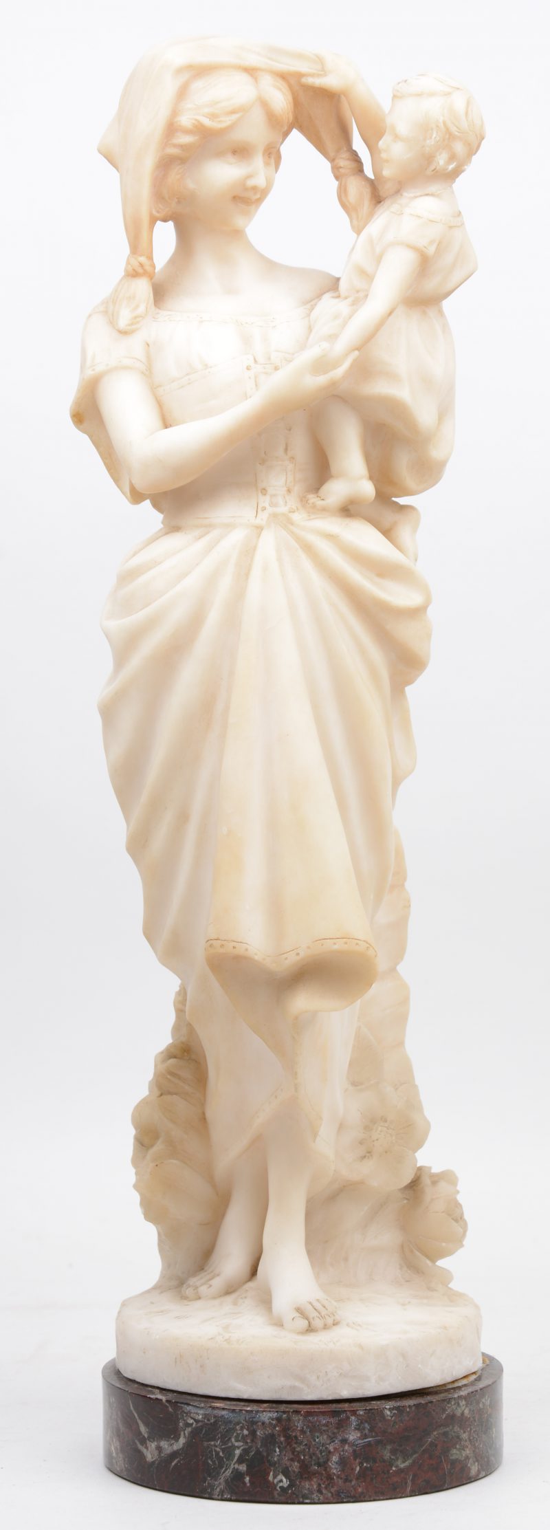 “Moeder met kind”. Een gebeeldhouwd albasten beeld. Achteraan gesigneerd. Firenze, Italië. Eerste helft XIXe eeuw.