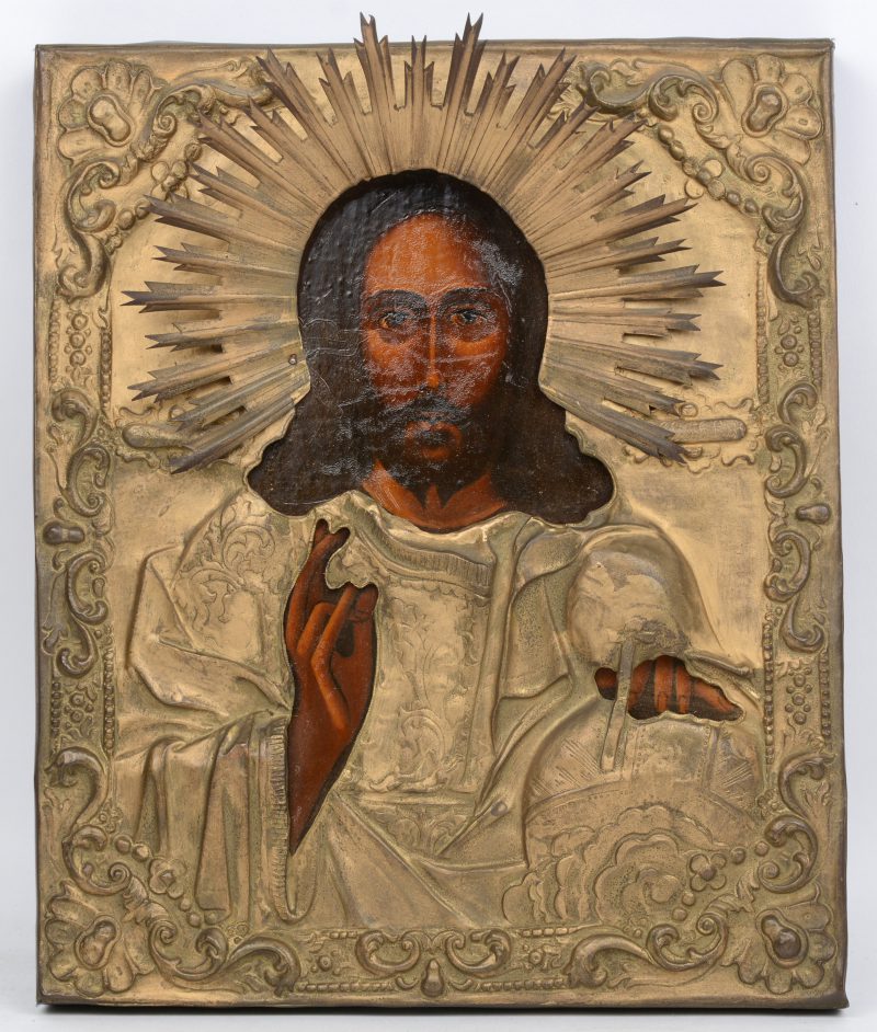 Een handgeschilderde icoon met beeltenis van Christus en met messingen riza.