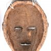 Twee deels witgepatineerde Afrikaanse houten maskers.