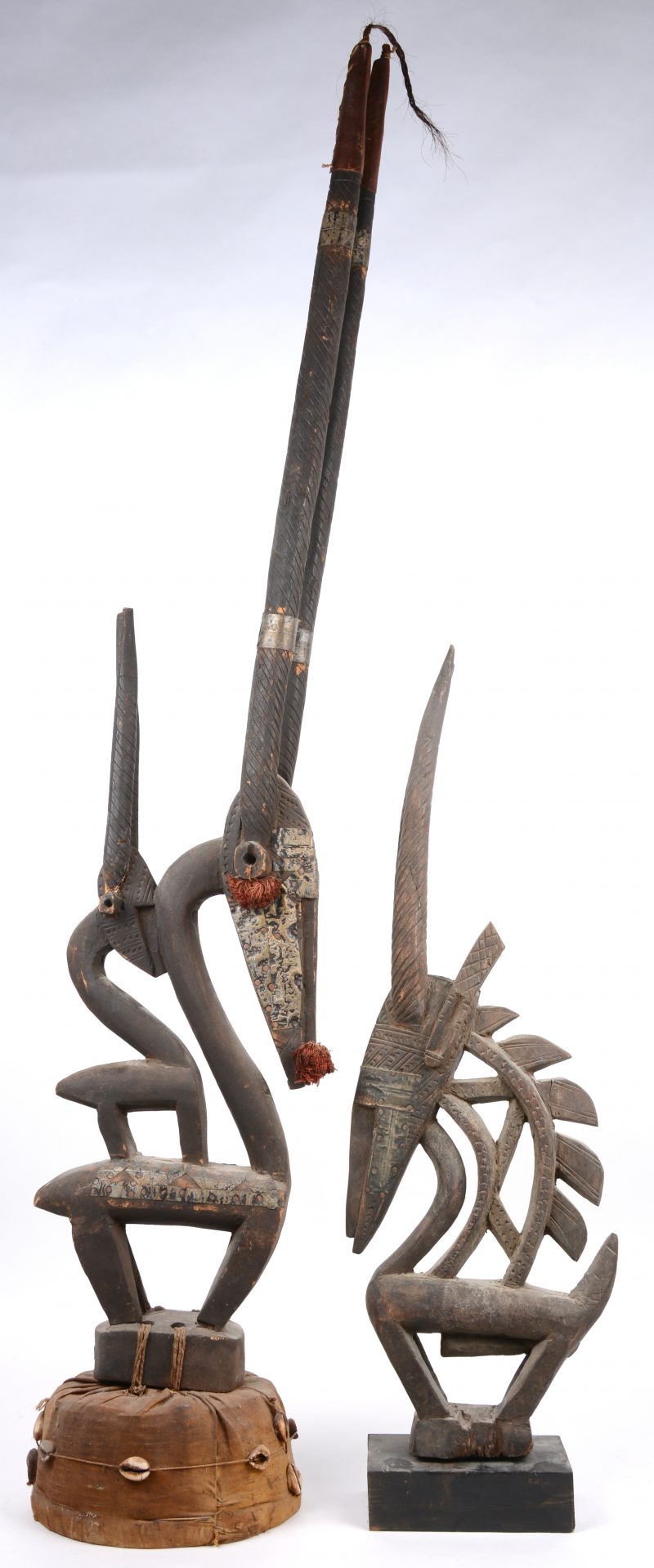 Twee ceremoniële Afrikaanse houten beelden in de vorm van een dier. Hoorns van de grootste hersteld.